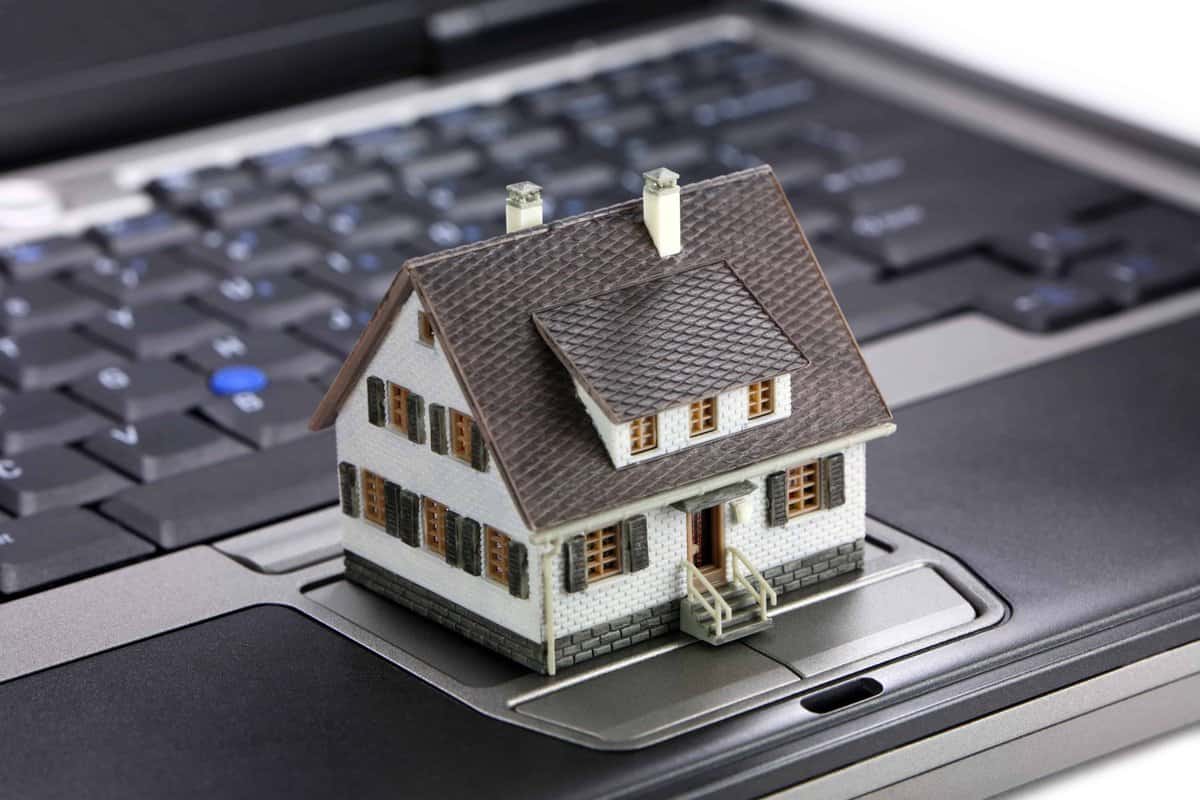 A HUD model house on a laptop keyboard.